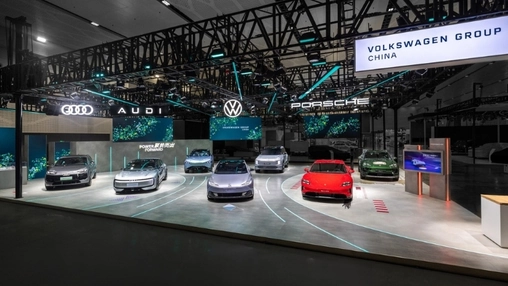 Volkswagen Group China motor show stand with Audi, VW, and Porsche vehicles displayed under branded signage